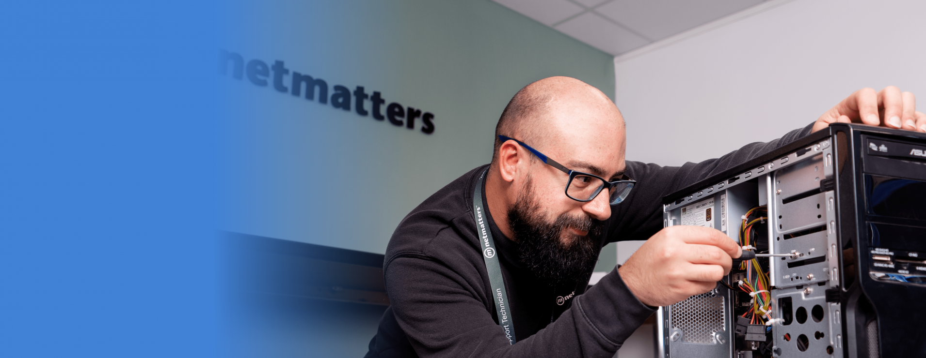 An image of a man doing work on the inside of an open computer.